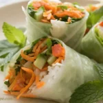 Fresh Kimchi Spring Rolls with vegetables and herbs wrapped in rice paper